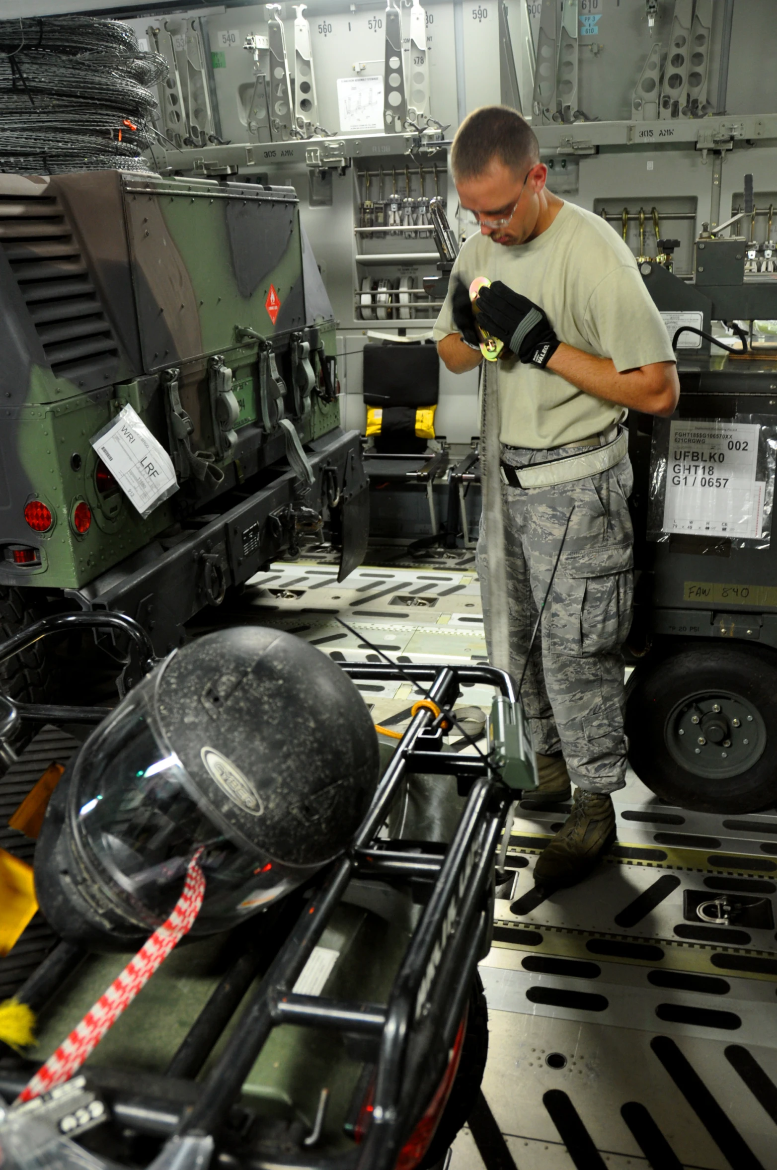 a man is inspecting the components of a machine in a factory