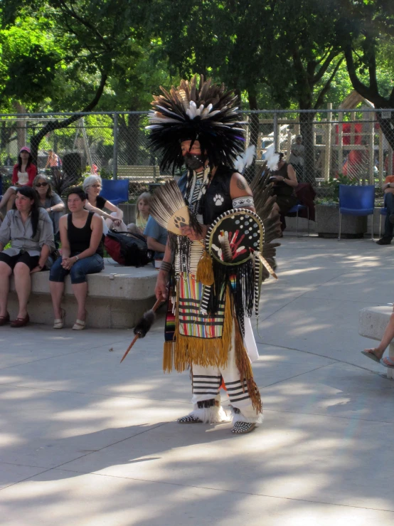 an indian man is dressed in costumes and waiting on someone