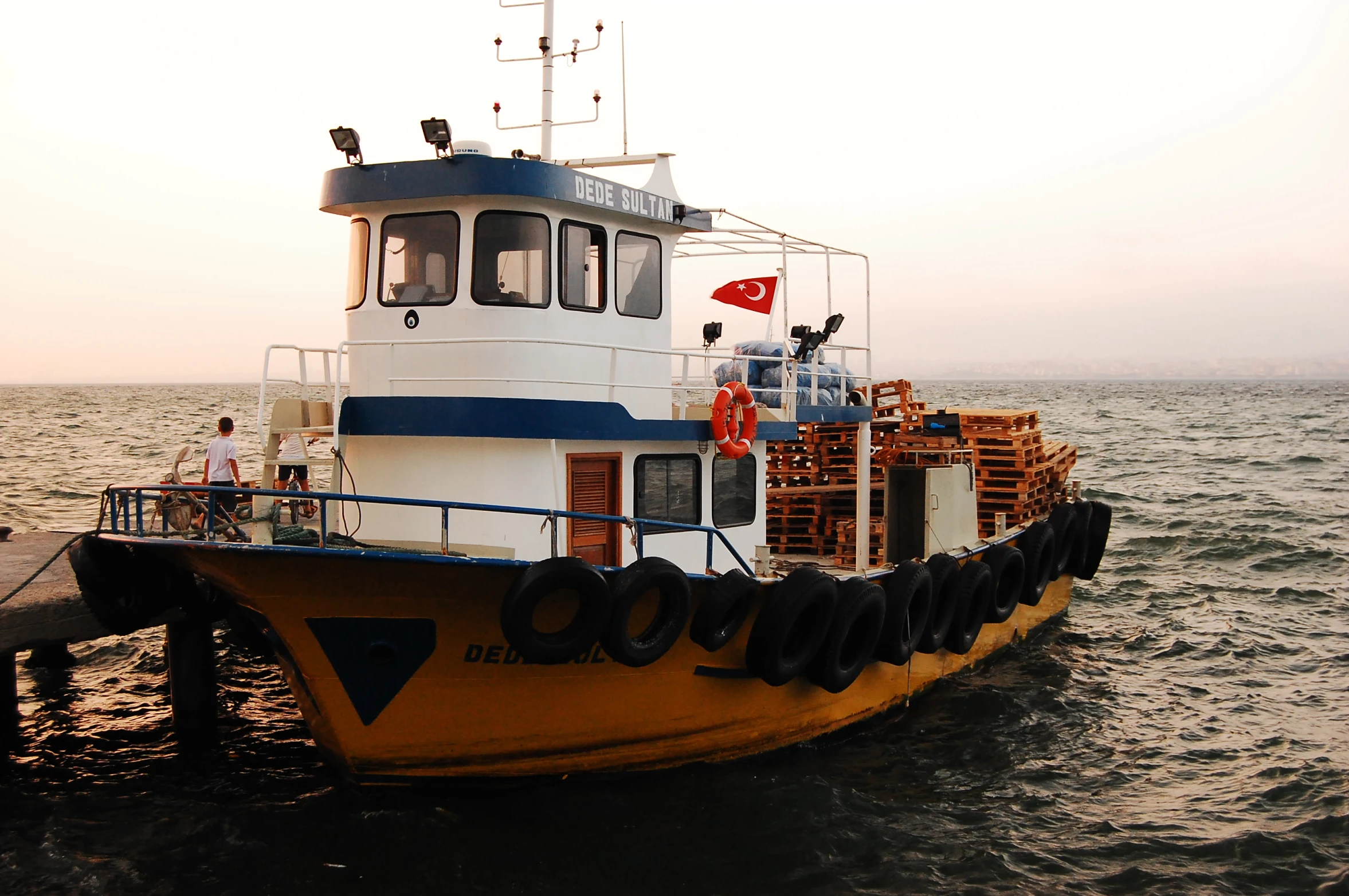 a tug boat out in the water with it's deck down