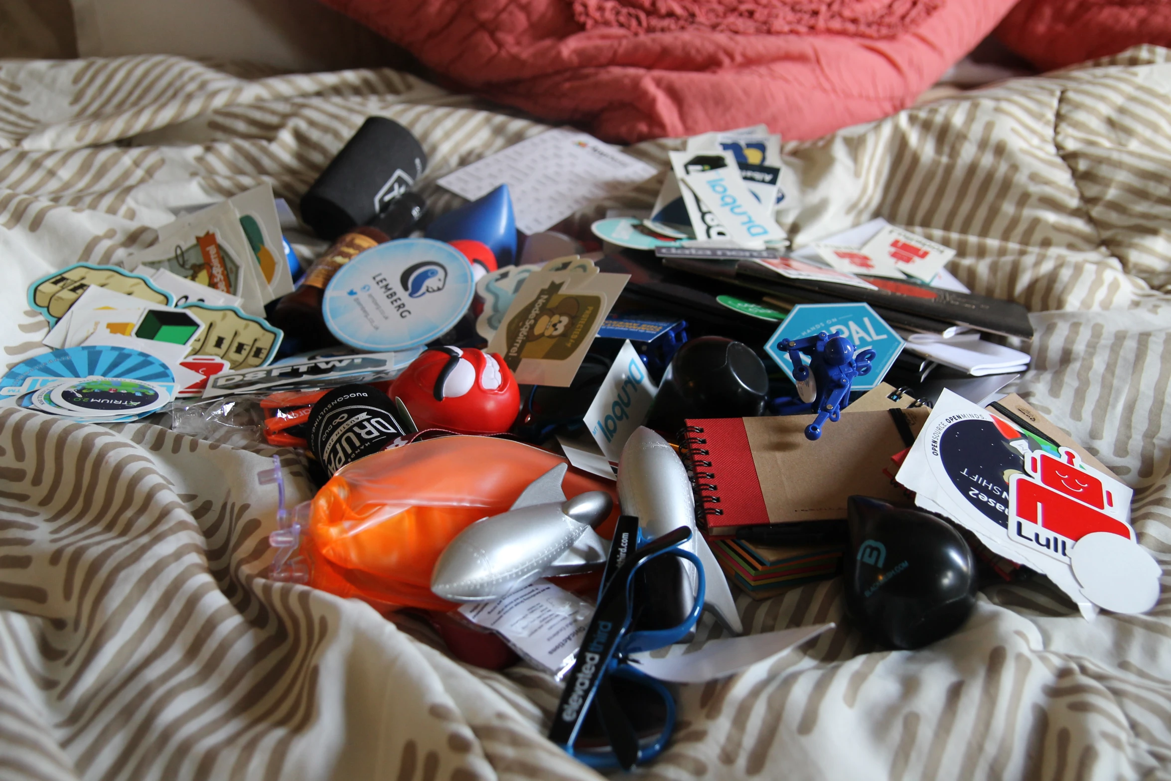 various objects are piled on top of a bed