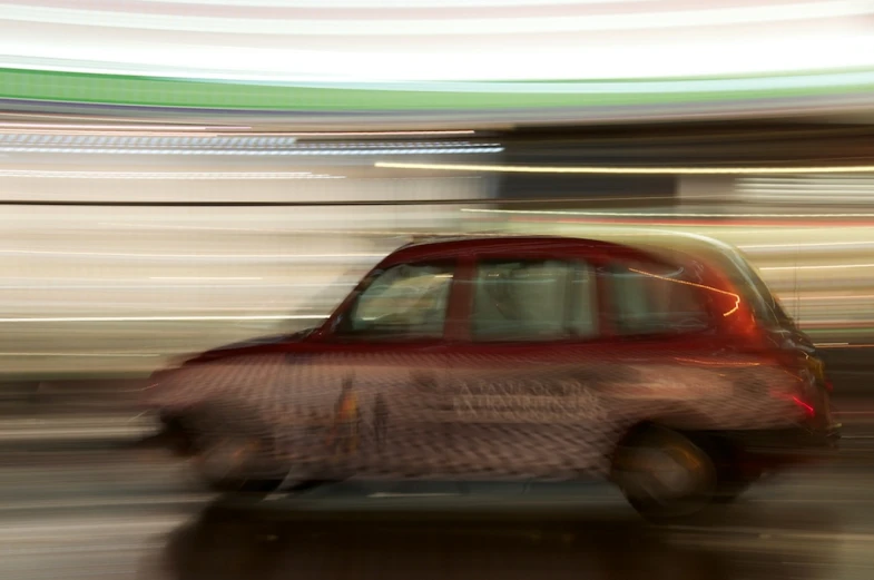 a blurred image of a car moving in the street