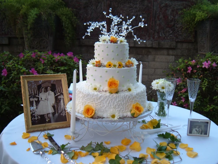 a cake sitting on top of a table next to a framed po