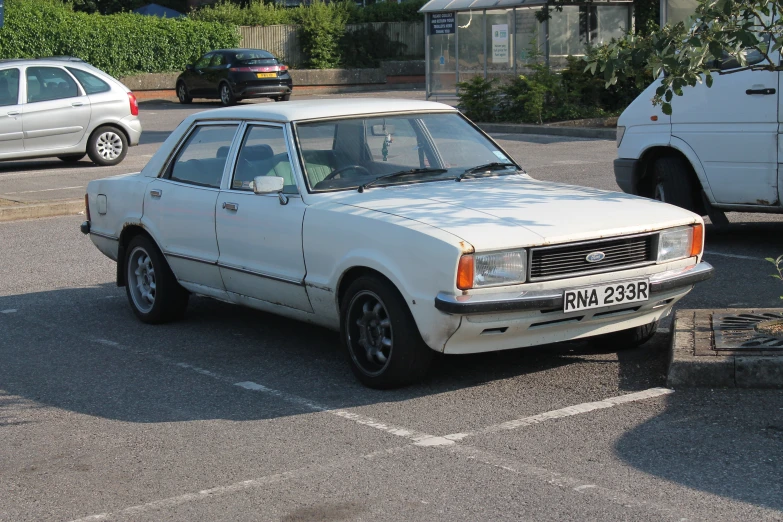 a car parked in the parking space next to a truck