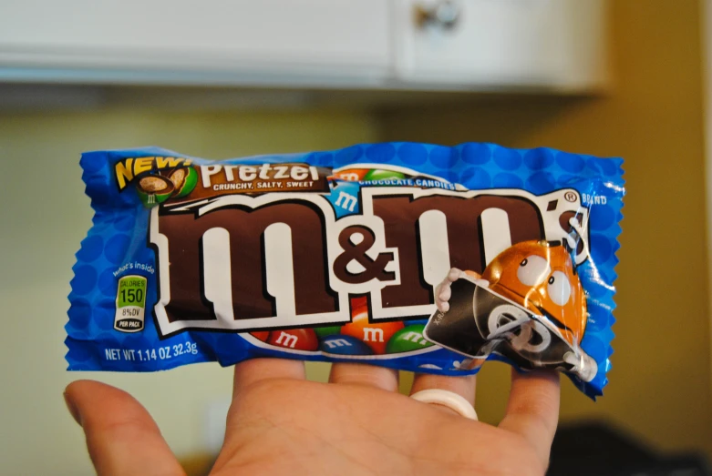 an image of a person holding a m & m bar