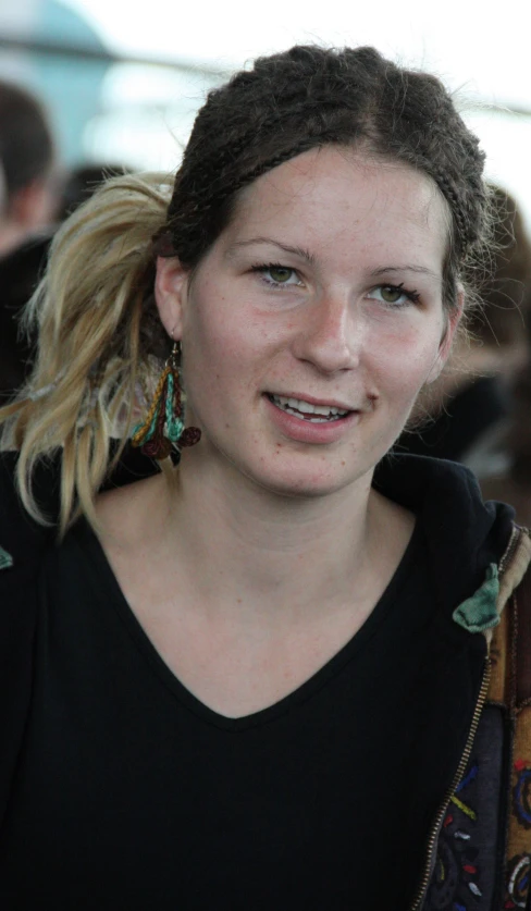 a close up of a person wearing an earring