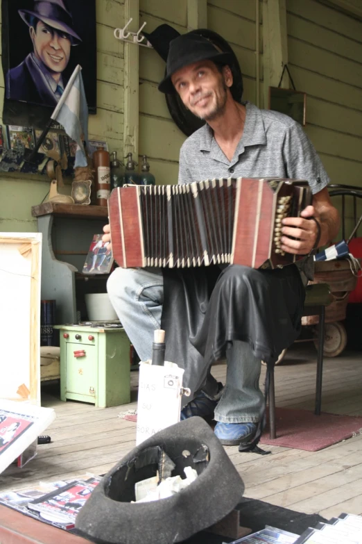 a man sits with an accordion in front of him