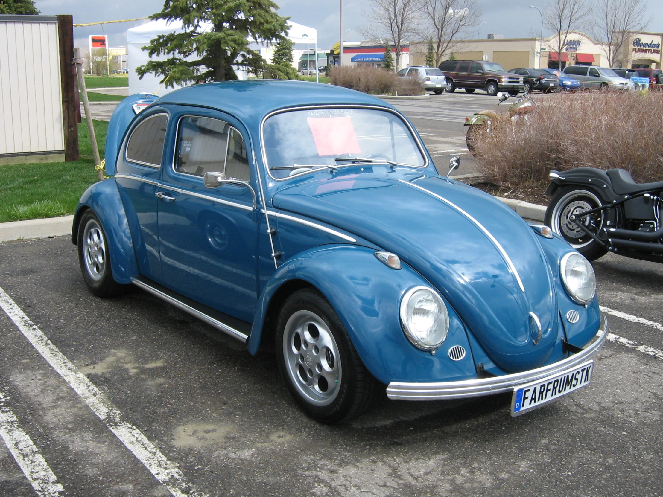 a very nice looking blue car in a parking lot