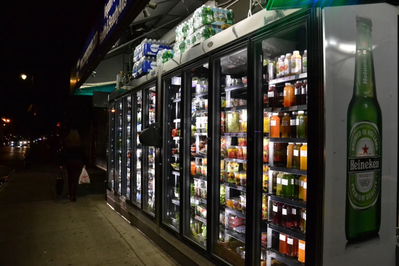 a display of beverages and drinks in lighted coolers