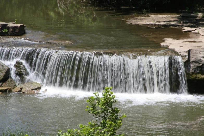 a small waterfall with water cascading from it