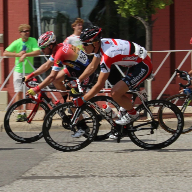 a group of cyclists race during a bib