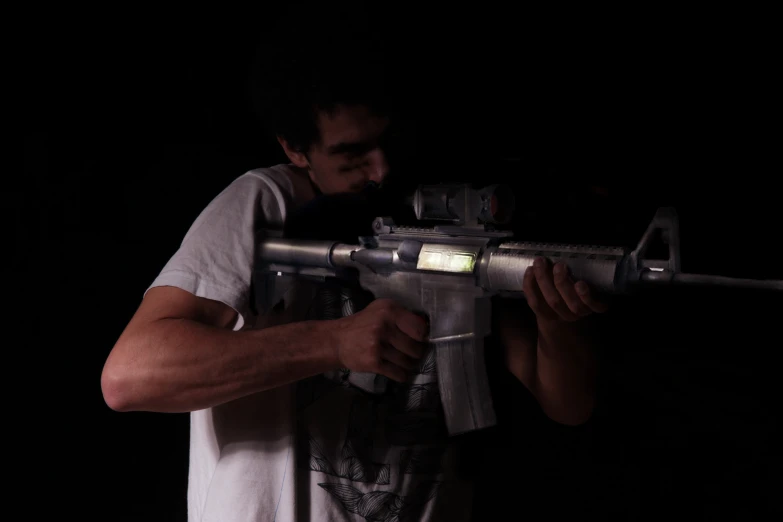 man with machine gun and flashlight on dark background