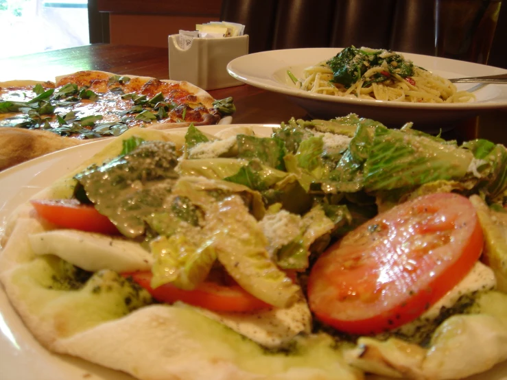 a plate filled with pizza and lettuce