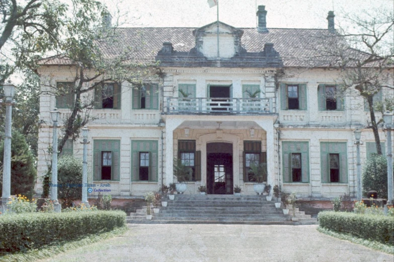 the entryway to an historic home where two men are about to walk into the front door