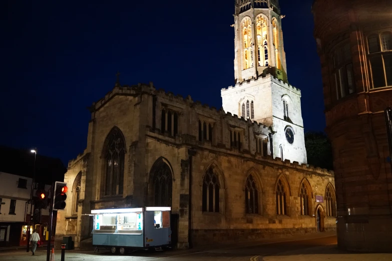 a tall clock tower towering over a city at night