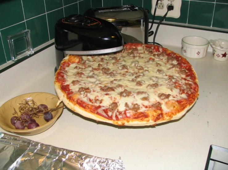 a pizza is topped with meatballs and cheese