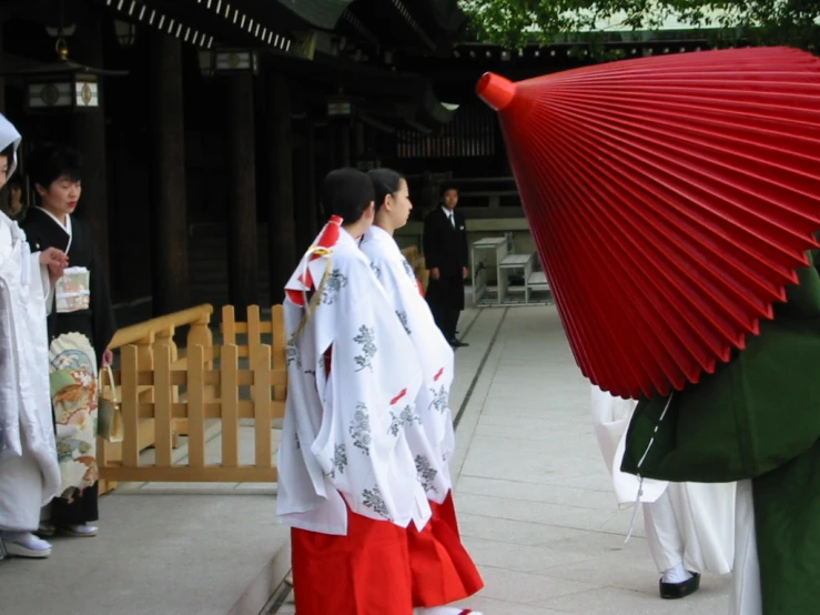 several people standing around wearing red and white costumes