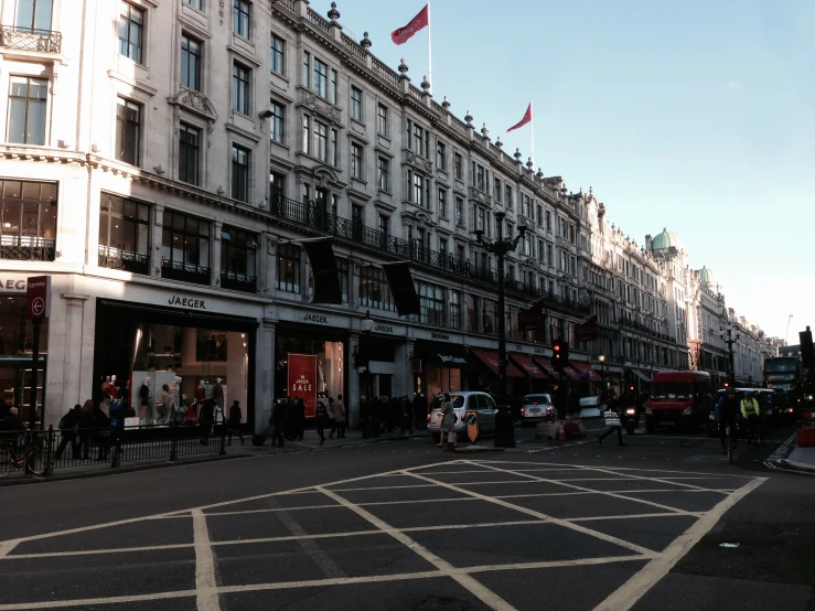 a busy city street with a double decker bus on the street