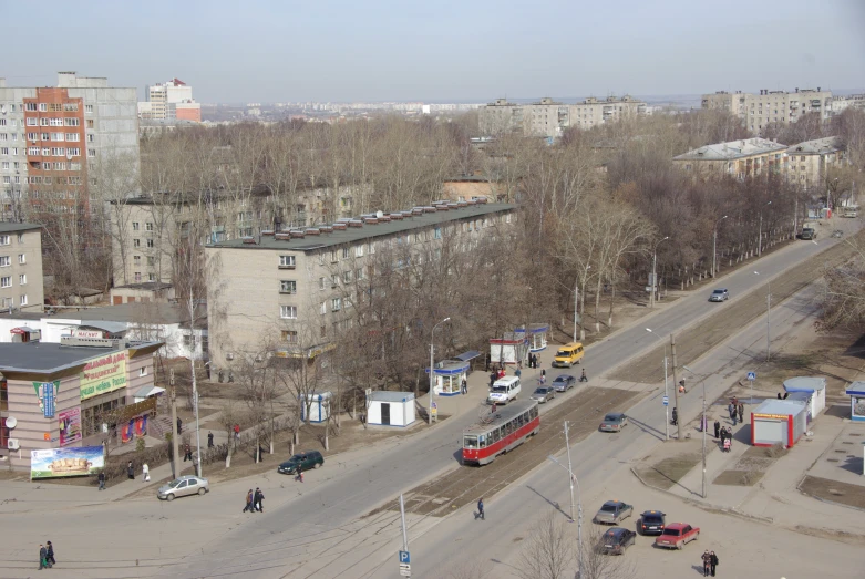 a bus is driving down a road next to tall buildings