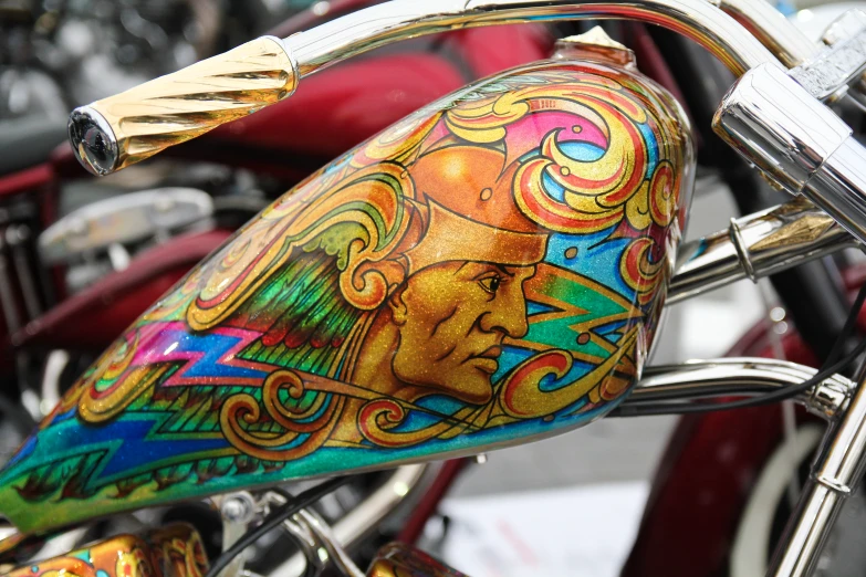 the side view of a painted motorcycle in front of some motorcycles