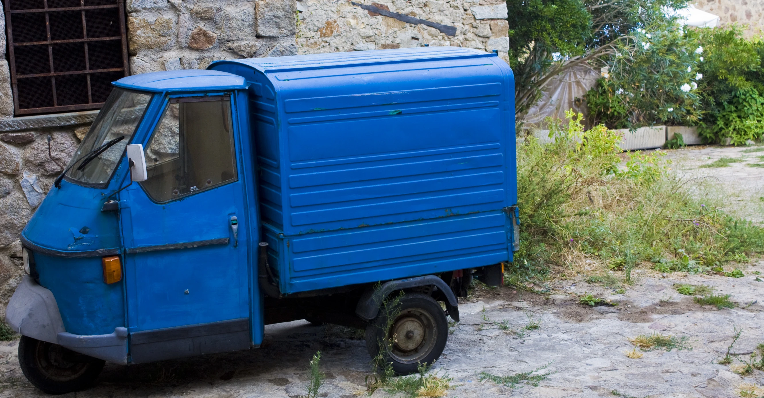 a truck sits parked by an old building