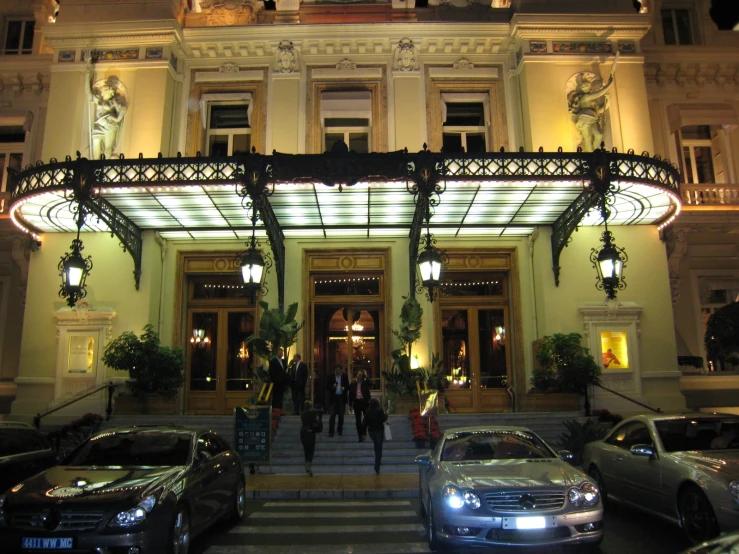 cars outside a very fancy el at night