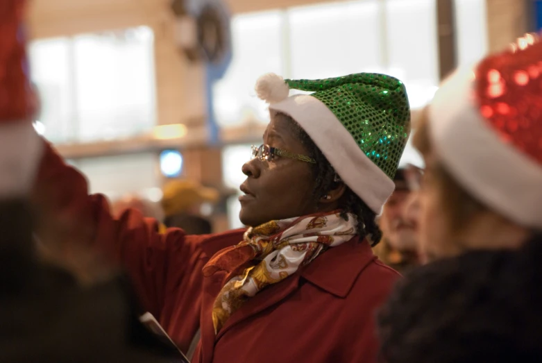 a man is wearing a green hat and red jacket