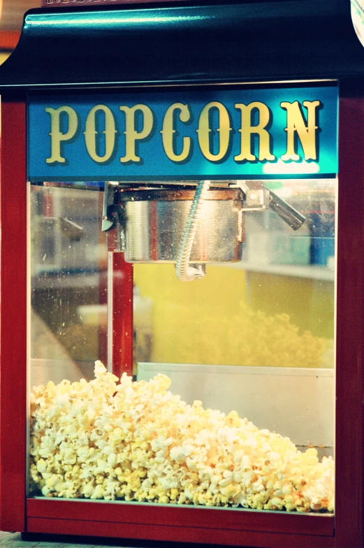 a popcorn machine with the word popcorn on the front