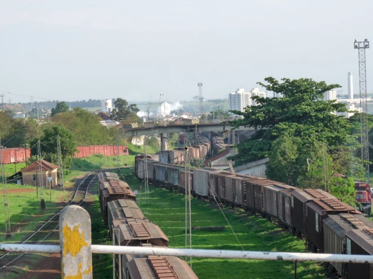 a train sits on the tracks next to a field