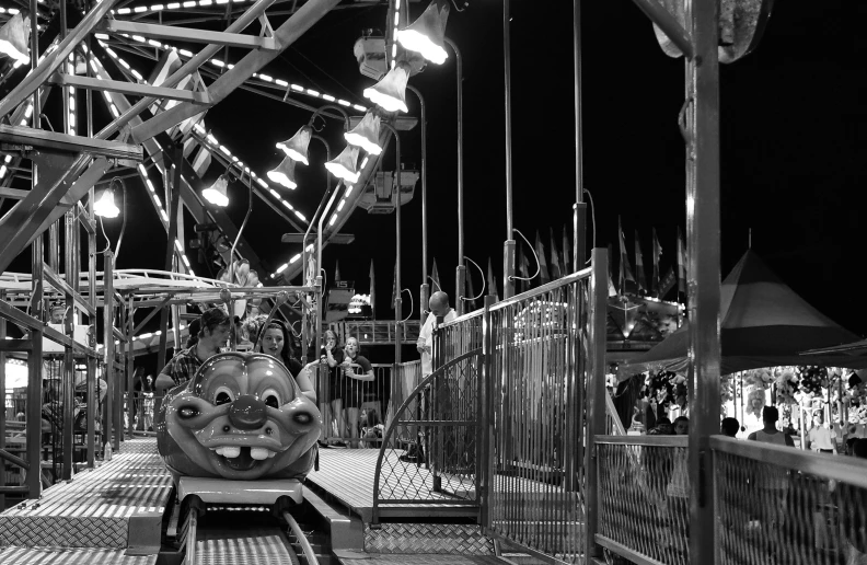 a carnival area with several rides at night