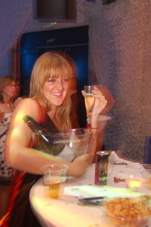 a woman holding a glass up to her face