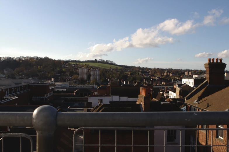 a panoramic s of a rooftop with a building in the background