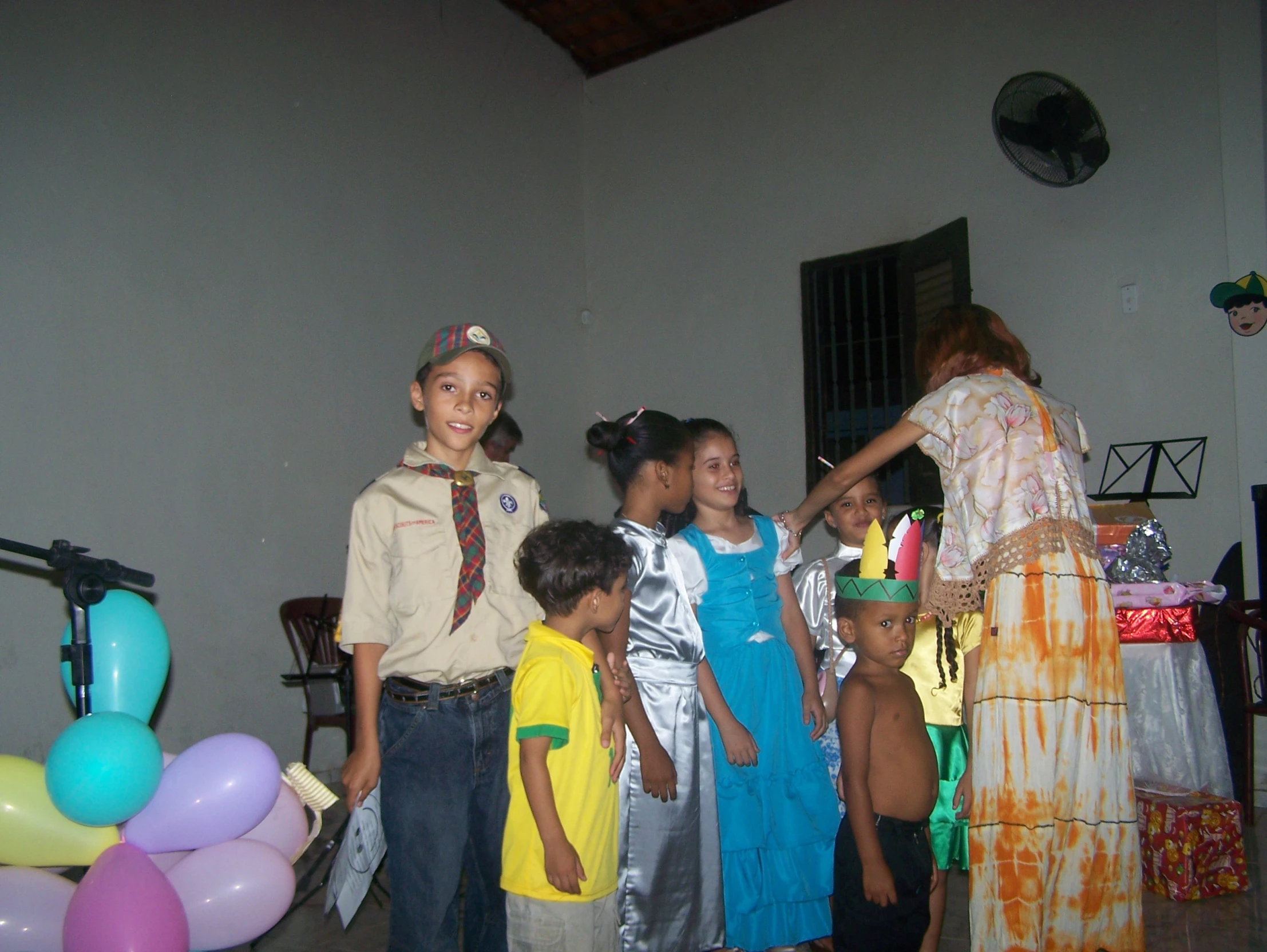 the children are dressed up in costumes with balloons