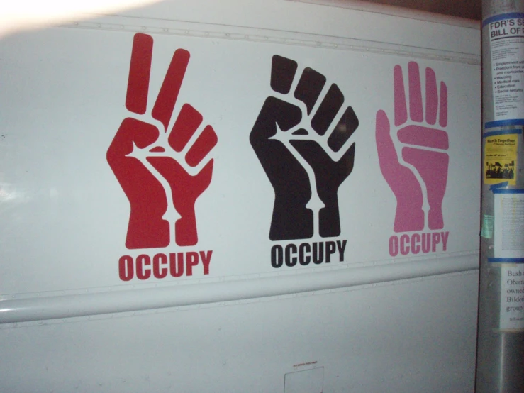 a sign on the side of the refrigerator that says occupy occupy