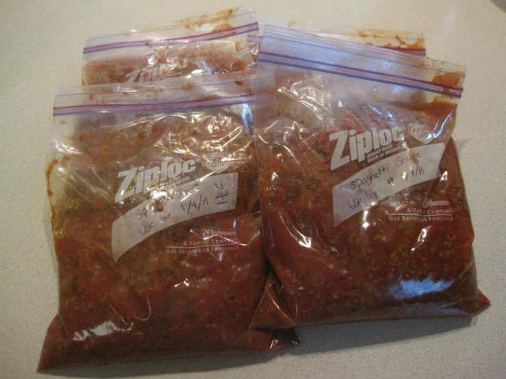 three bags of mixed food sitting on top of a counter