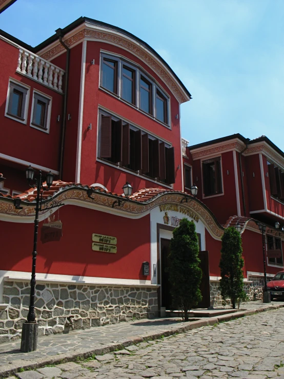 the front entrance of an oriental style red building