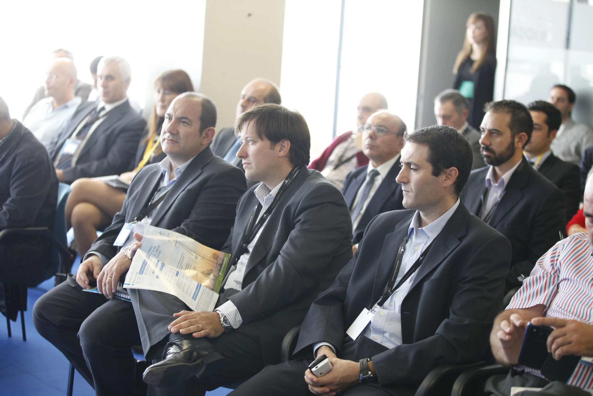 many people sitting in chairs while wearing business attire