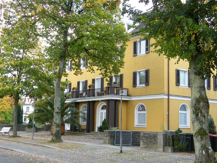 a yellow building with white trim on it