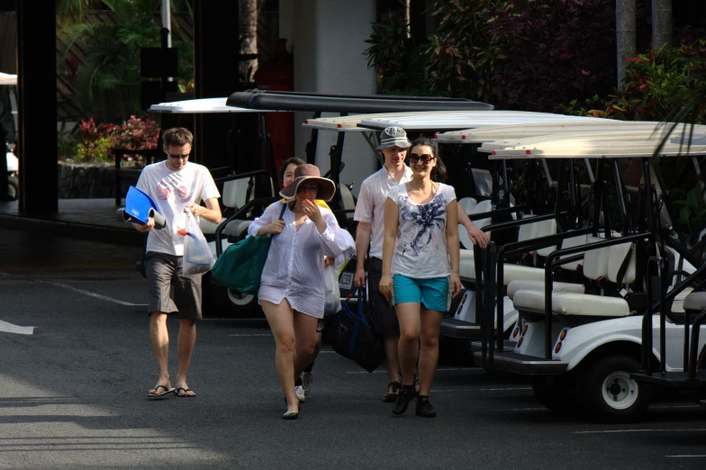 some people with white shirts are walking down the street