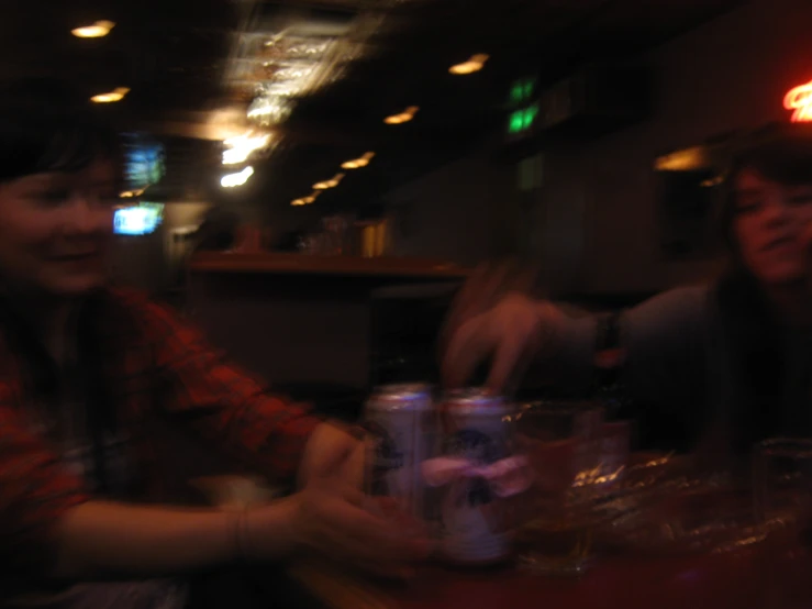 blurry image of two girls sitting at a restaurant table