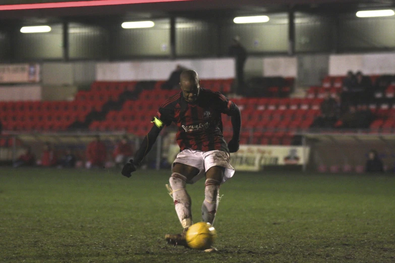 a soccer player about to kick a soccer ball