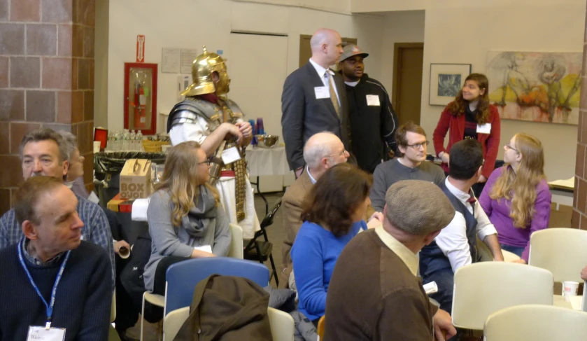 a group of people are listening to someone speak