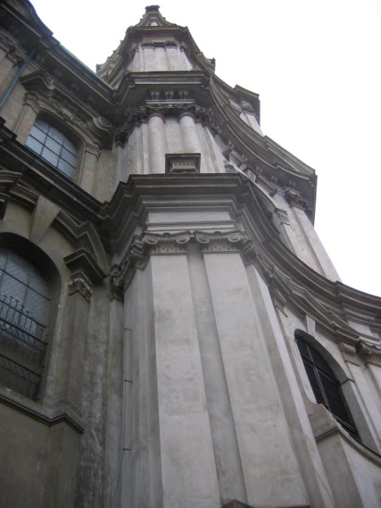 an ornate building with black shutters on its windows