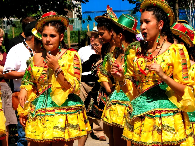 there are several women dancing together wearing costumes
