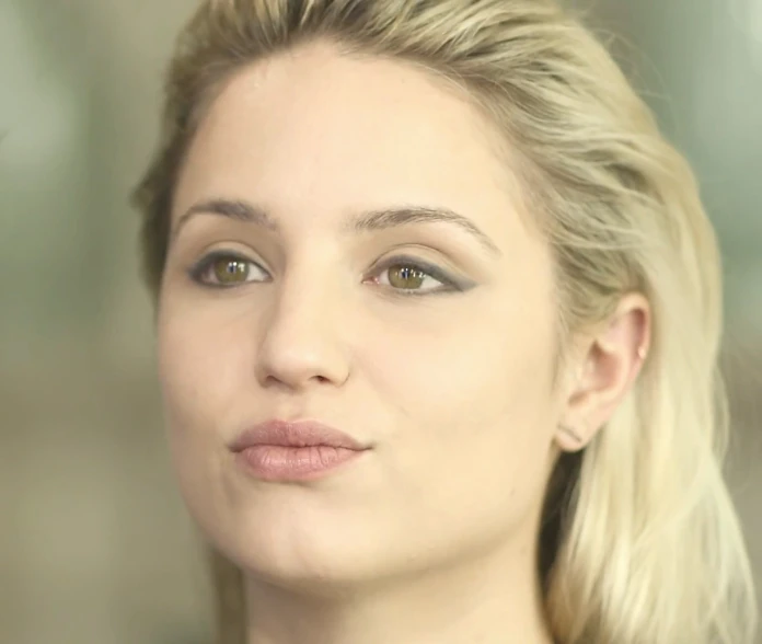 a blond girl posing for a camera with her hair down