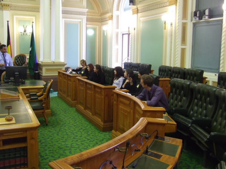 a group of people sitting in a courtroom