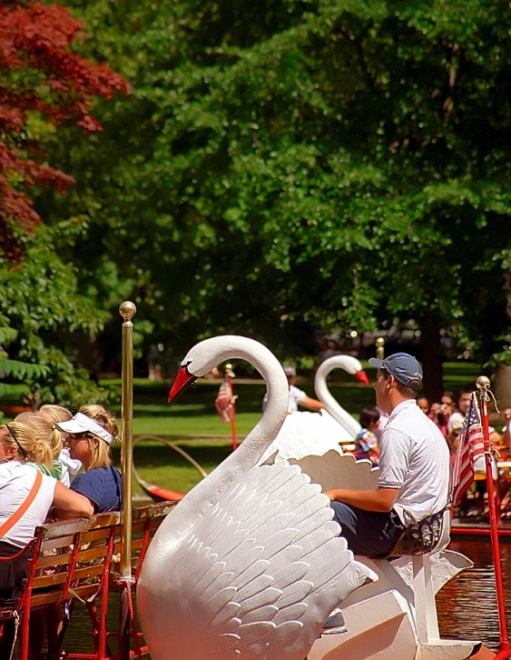 a swan statue in the middle of an outdoor meal area