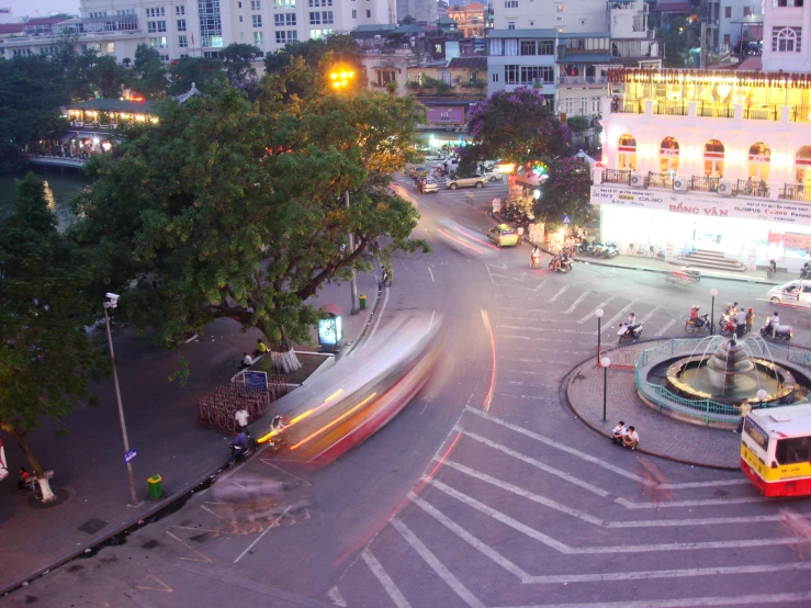 a train crossing in a busy intersection at dusk