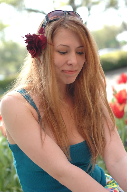 a woman with red flowers in her hair