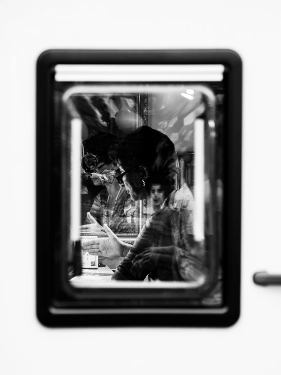 man in black and white reflection from his vehicle window