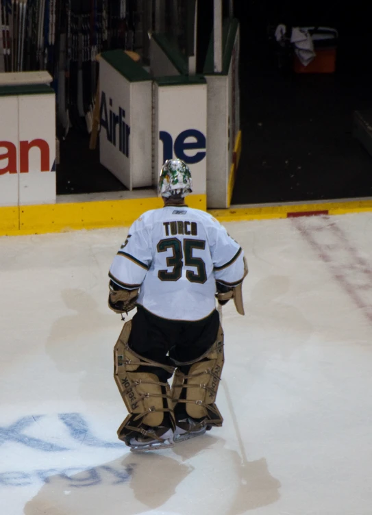 an ice hockey player in white jersey walking